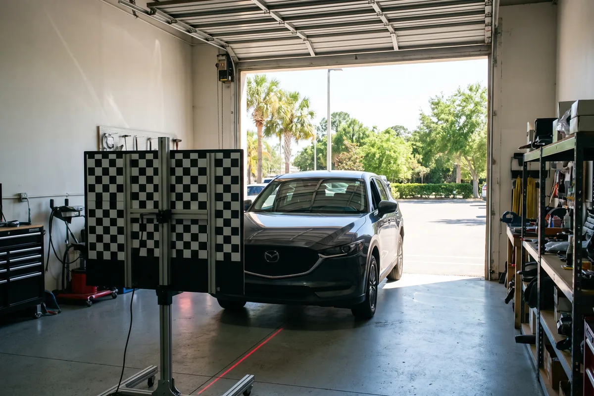 ADAS camera calibration target in front of an SUV in Palm Bay
